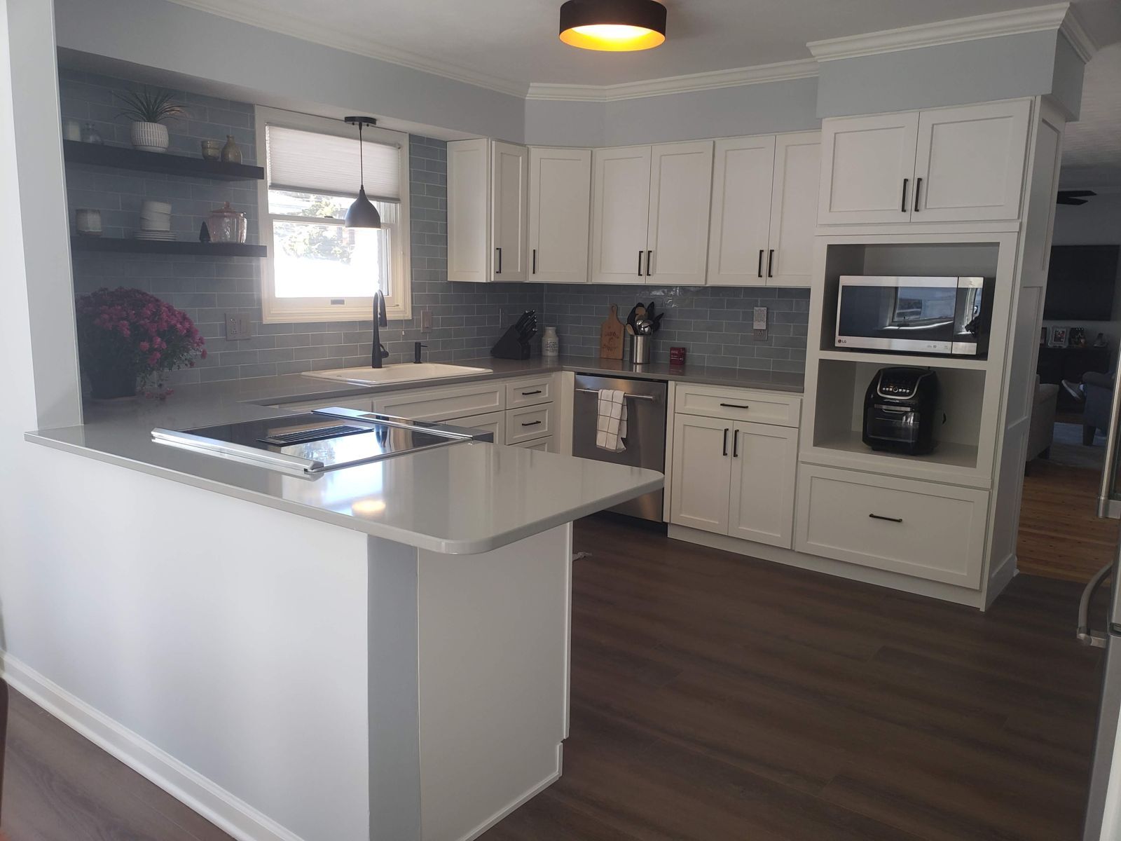 The same kitchen after, white Shaker cabinets