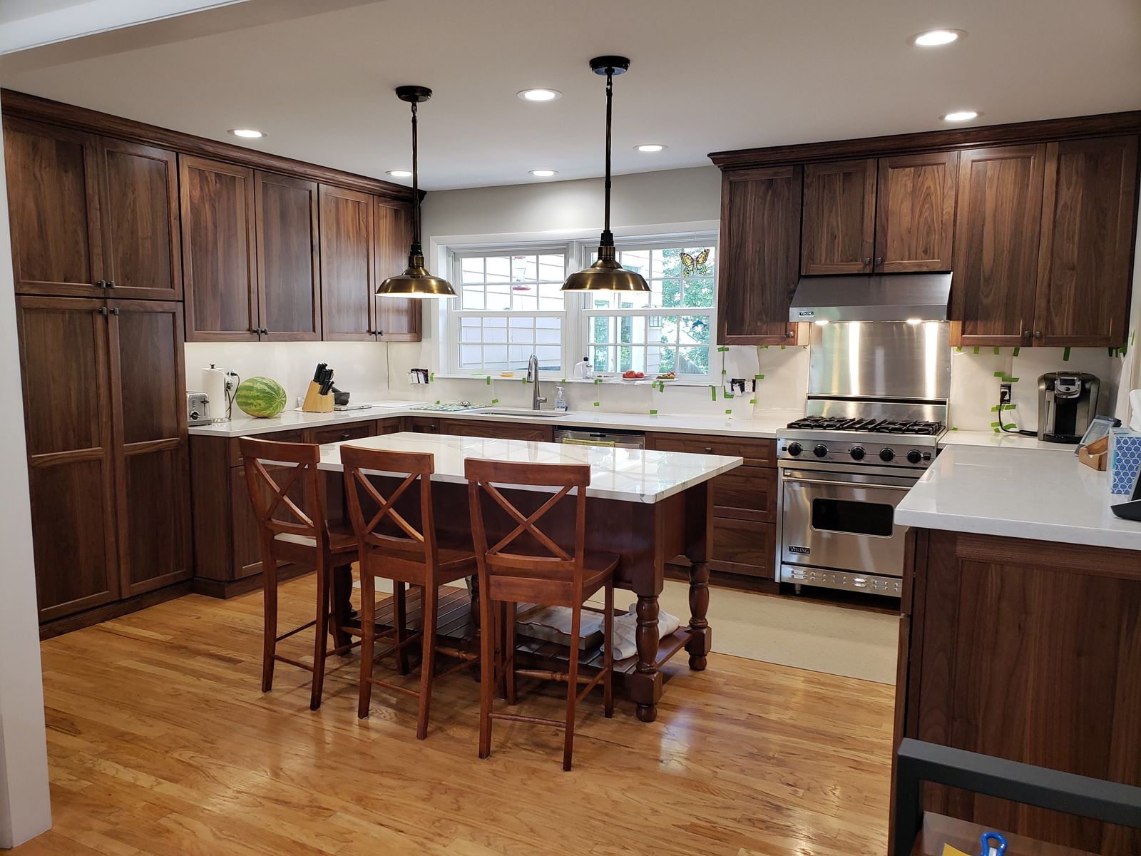 The same kitchen after, walnut cabinets