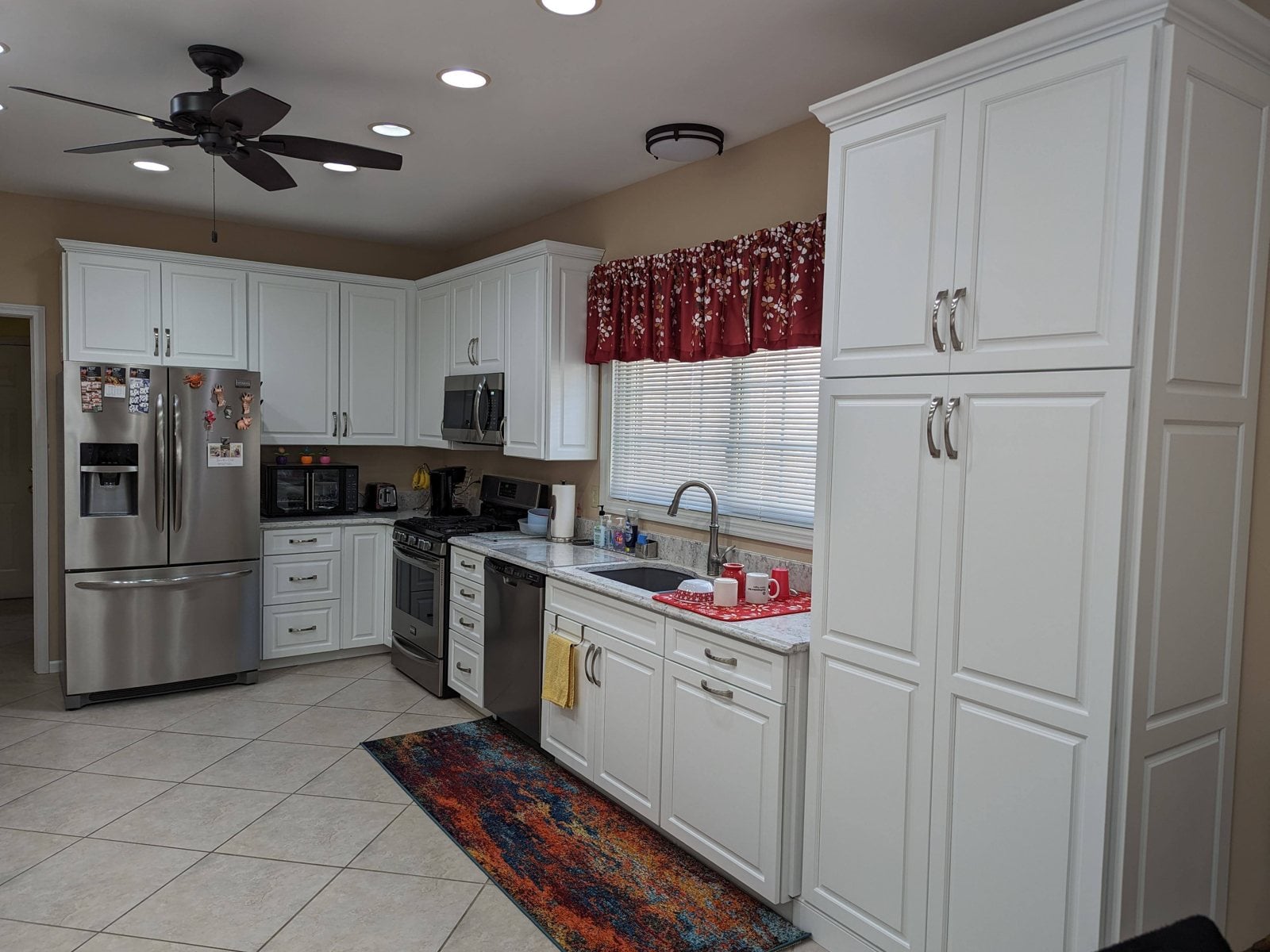The same kitchen after, white cabinets