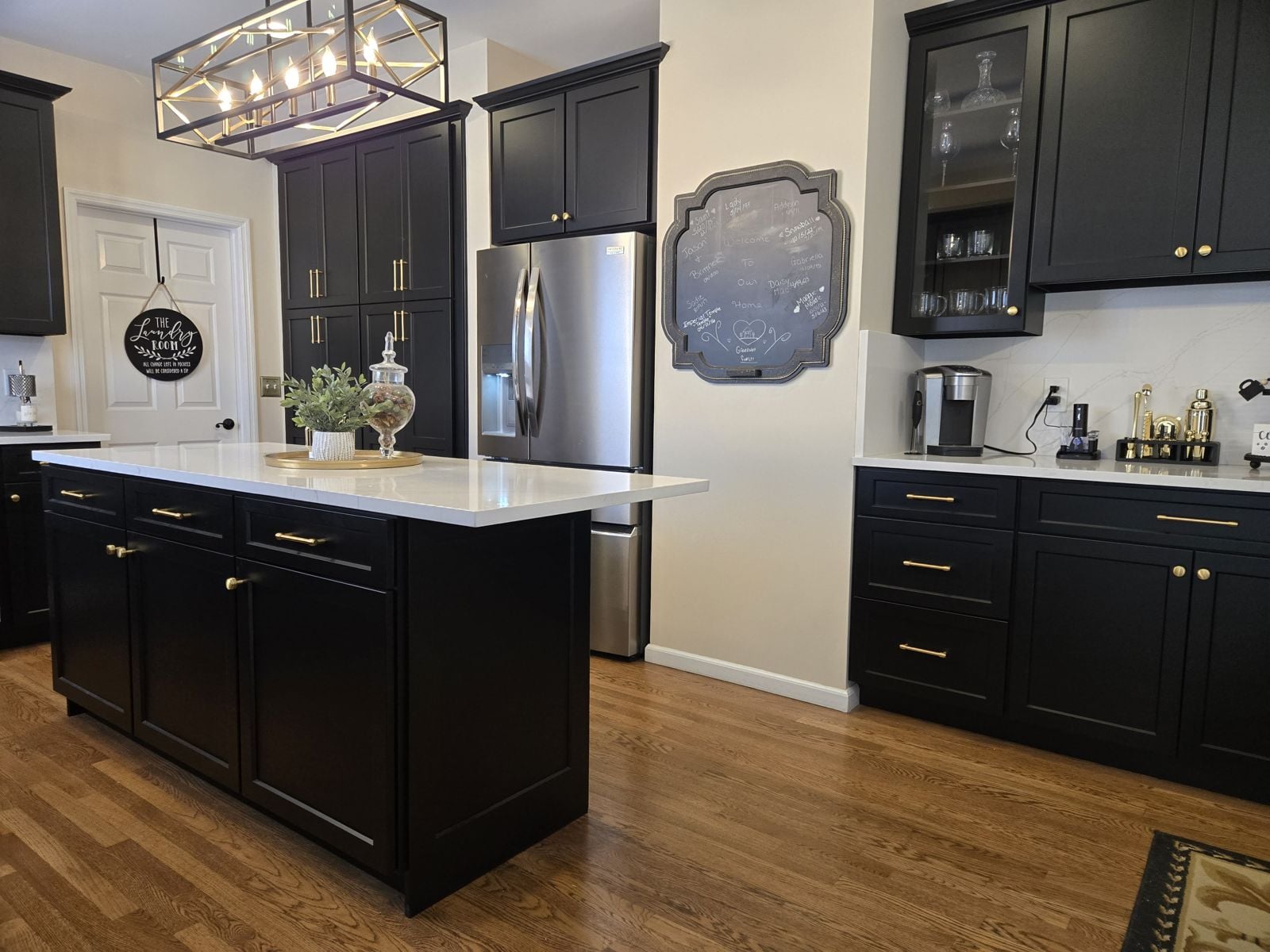 Black painted cabinetry with a matching island
