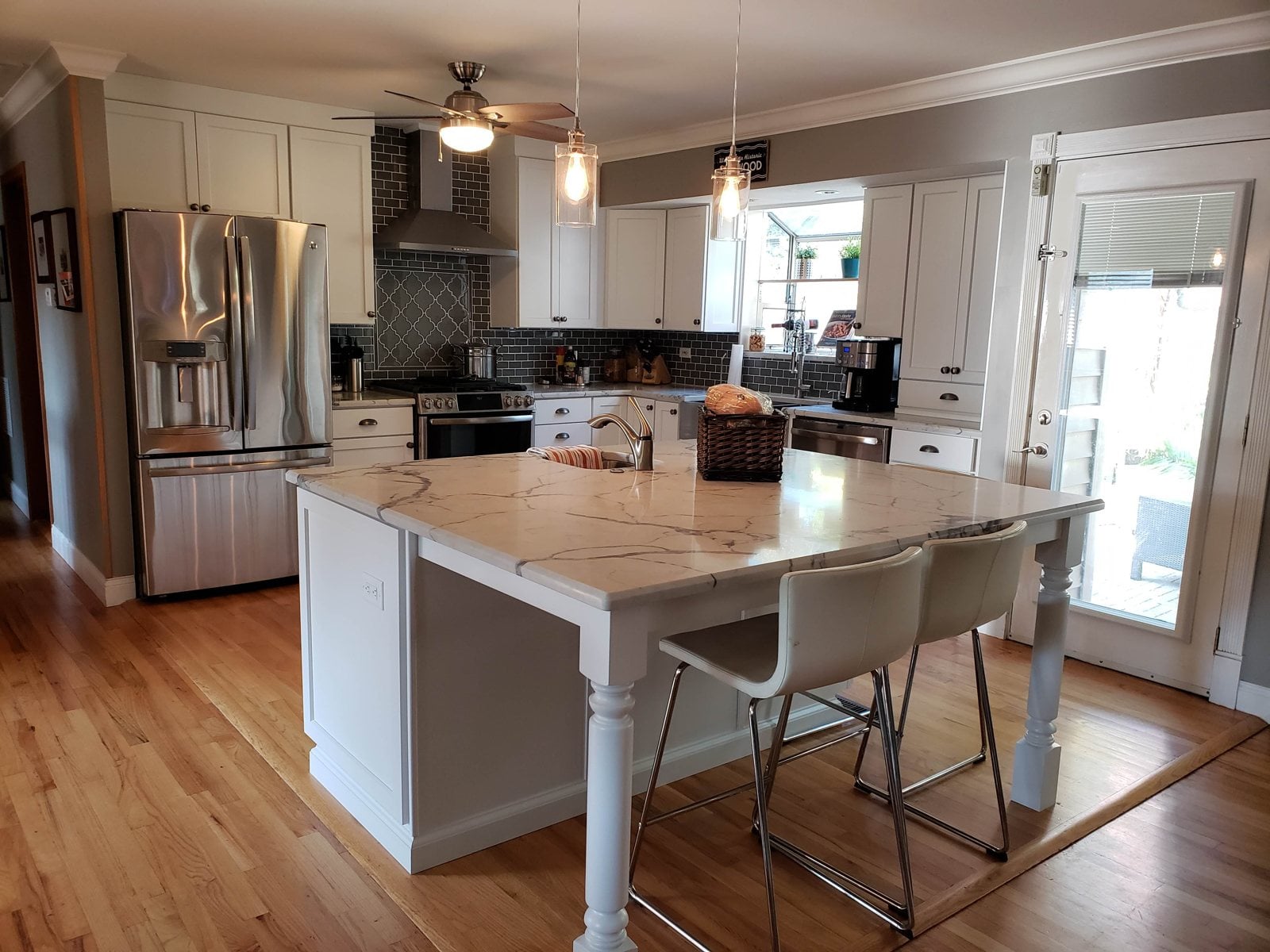 White kitchen with a large island and seating