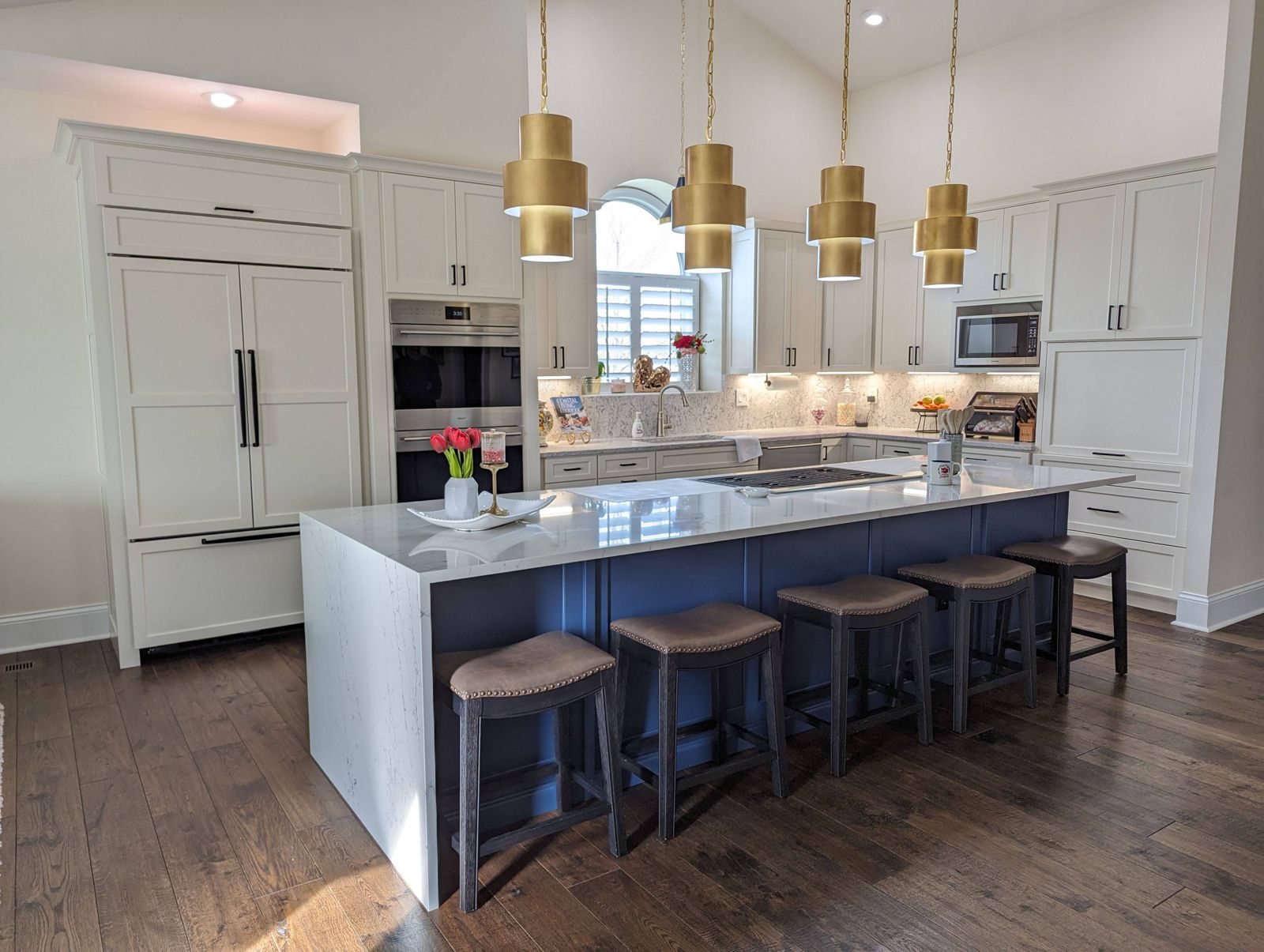A Fresh Faced kitchen with white cabinetry and a navy island