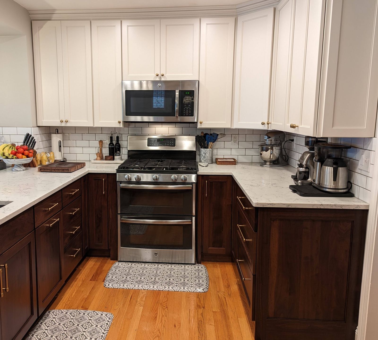 A two-tone Fresh Faced kitchen with antique white uppers and walnut lowers